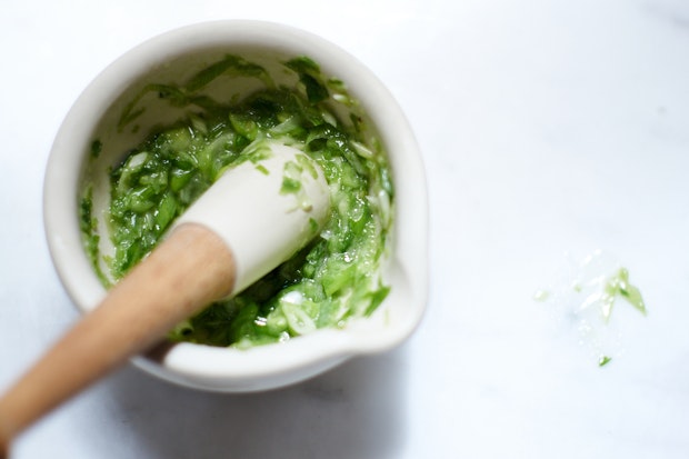 Coconut Sauce Ingredients Being Crushed in Mortar and Pestle