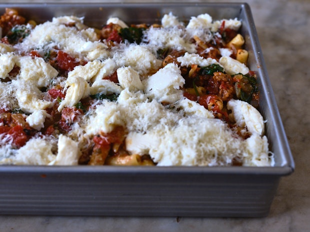 ingredients for baked ziti in a baking tin ready to go into oven