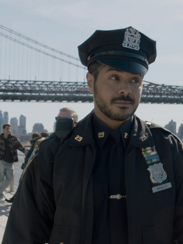 Badillo in uniform, standing by the bridge on Blue Bloods Season 14 Episode 13