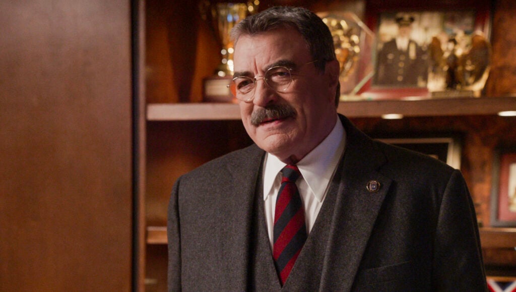 Frank standing in his office wearing a red and blue striped tie on Blue Bloods Season 14 Episode 12