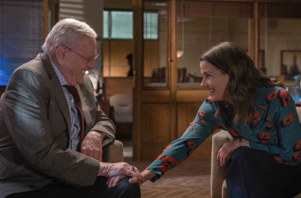 Erin smiles and puts her hand on Henry's knee in the DA's office on Blue Bloods Season 14 episode 13