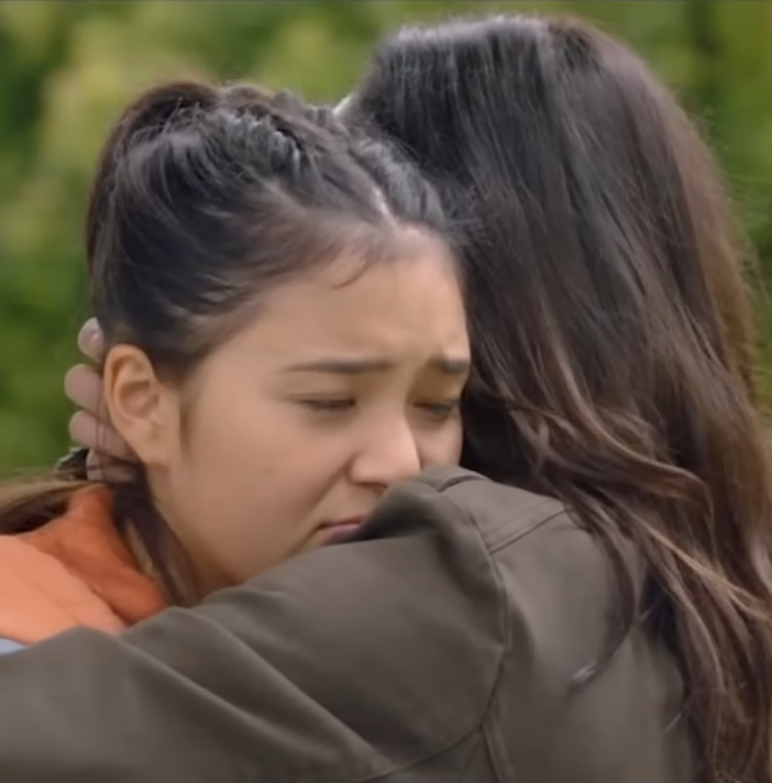 Chloe melts into her sister's embrace.