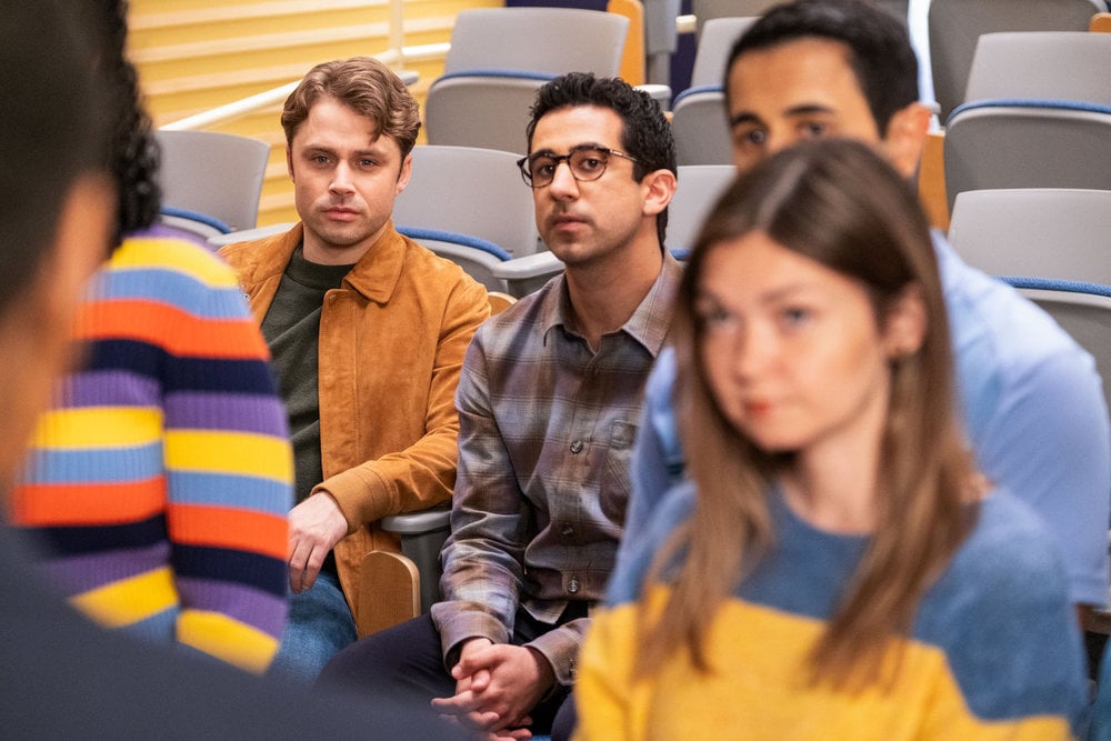 Rizwan sitting and watching an interaction on The Irrational Season 2 Episode 2