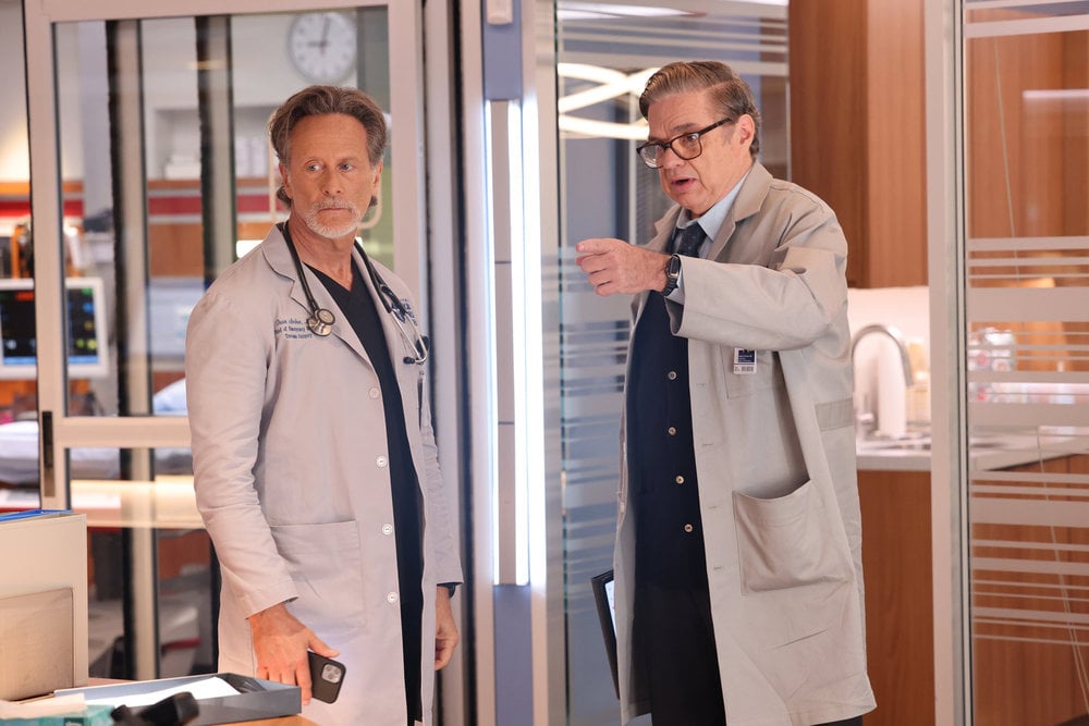 Dr. Charles standing with Archer and pointing to something offscreen on Chicago Med Season 10 Episode 4