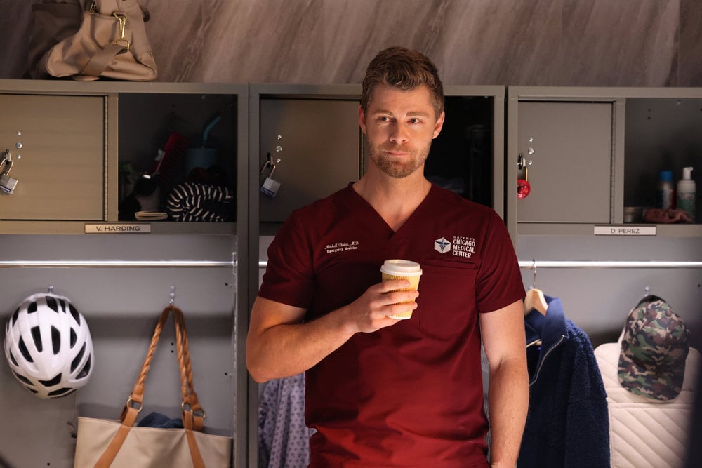 Ripley in the locker room holding a cup of coffee on Chicago Med Season 10 Episode 4