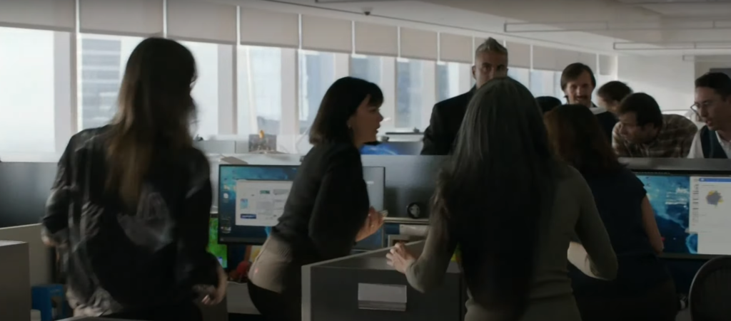 A bunch of people milling around an office staring out the window and gossiping with each other on Law & Order: SVU Season 26 Episode 5