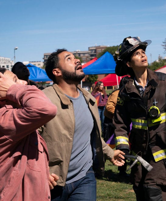 Stella stands with bystanders as they panic.