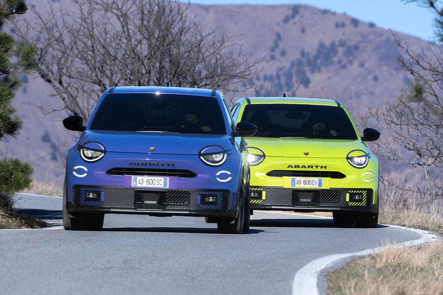 Purple and green Abarth 600e driving on a mountain road