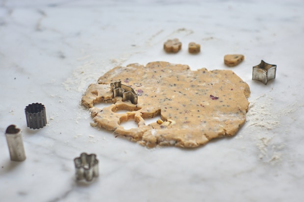 Rose Shortbread Cookie Dough Being Stamped with Small Animal Shaped Cookie Cutters