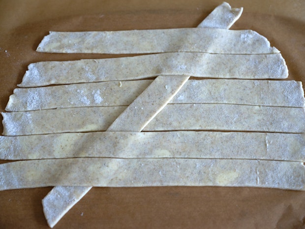 weaving strips of pie dough for a lattice crust