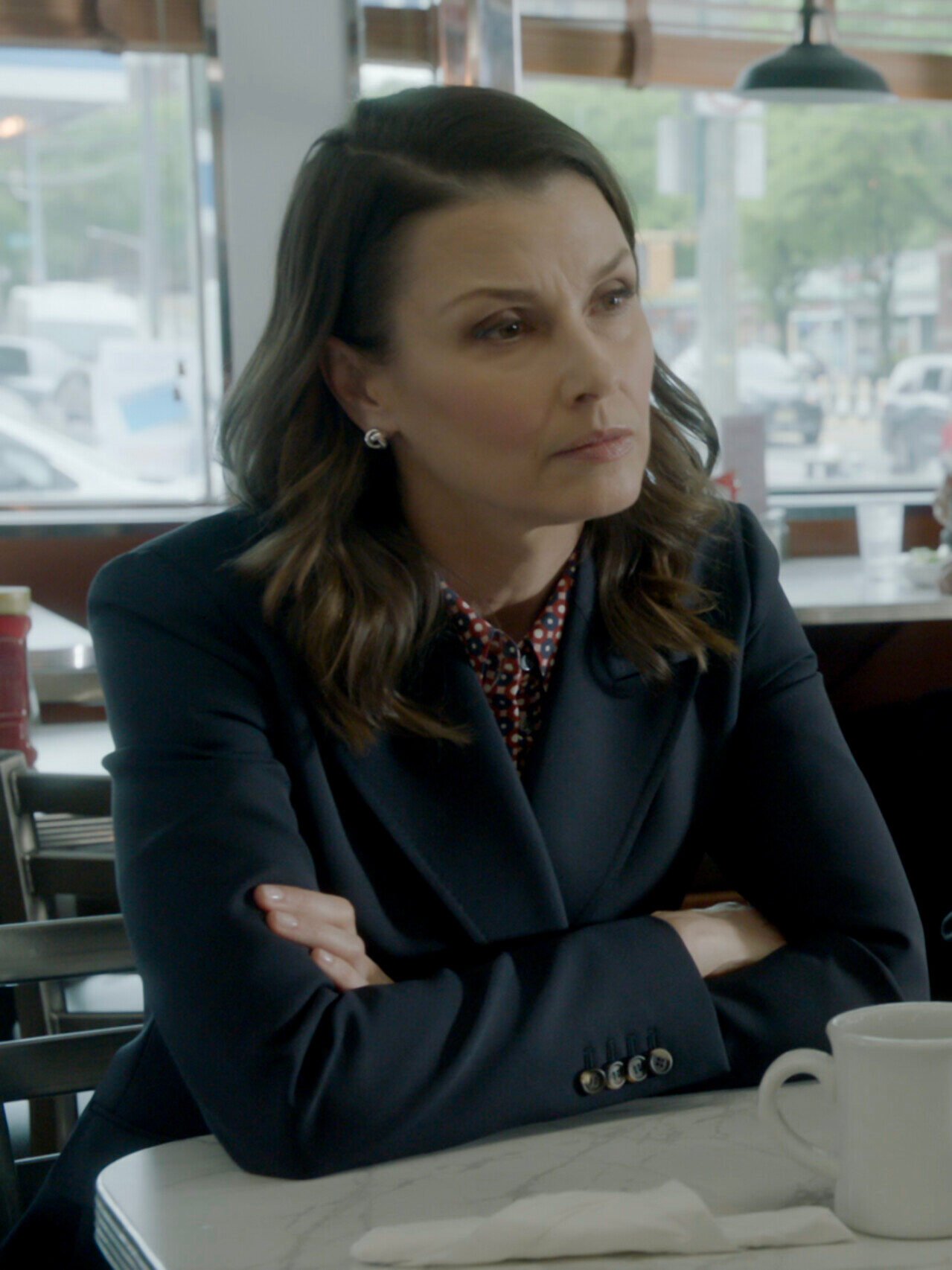 Erin and Anthony meet with someone at a restaurant on Blue Bloods Season 14 Episode 15