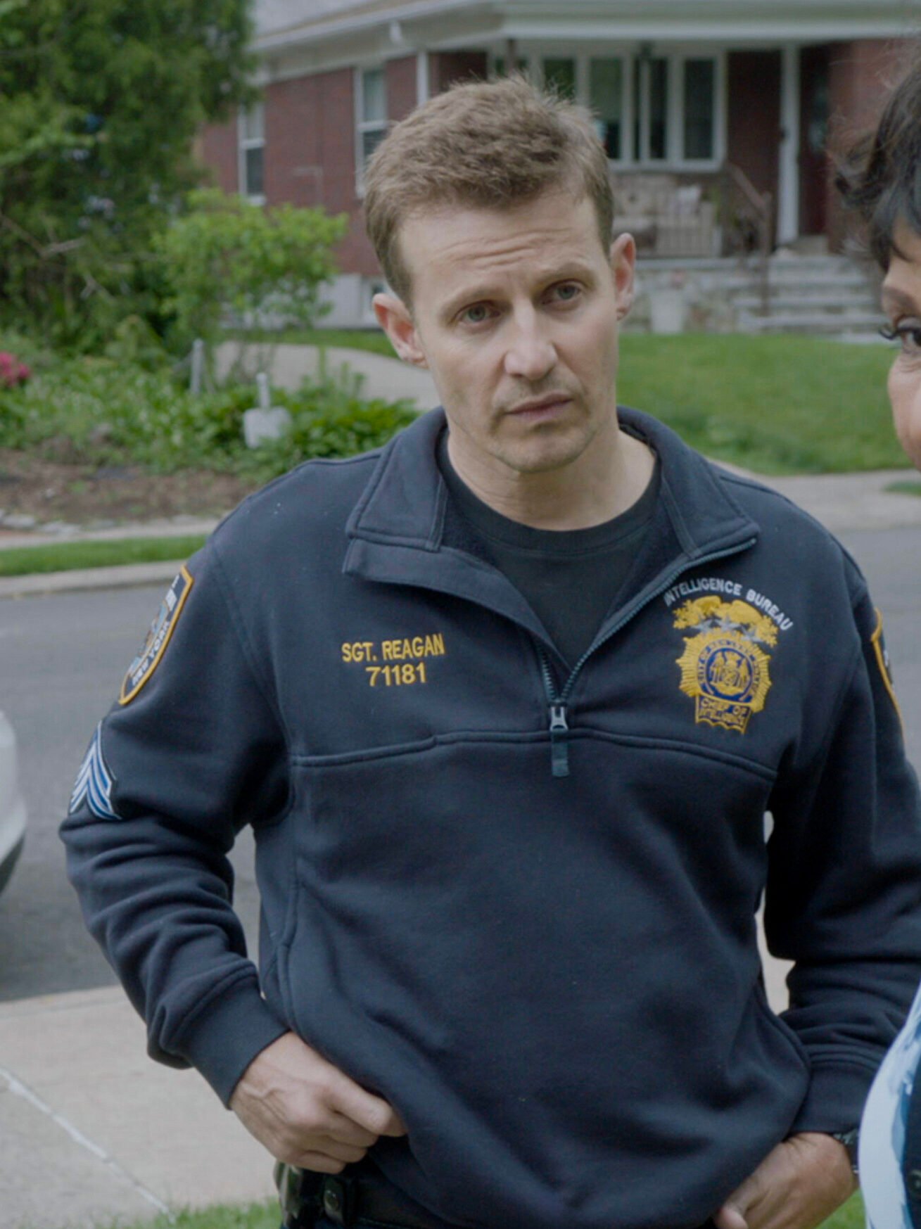 Eddie and Jamie standing outside Badillo's house talking to his mother on Blue Bloods Season 14 Episode 15