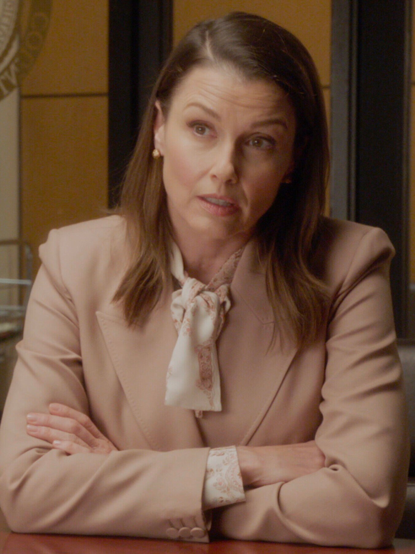 Erin sits with a defendant in her office on Blue Bloods Season 14 Episode 16.