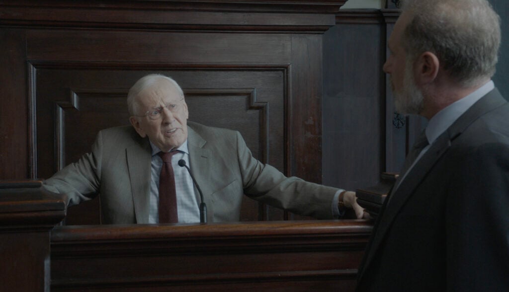 Henry on the stand answering the defense attorney's questions on Blue Bloods Season 14 Episode 13