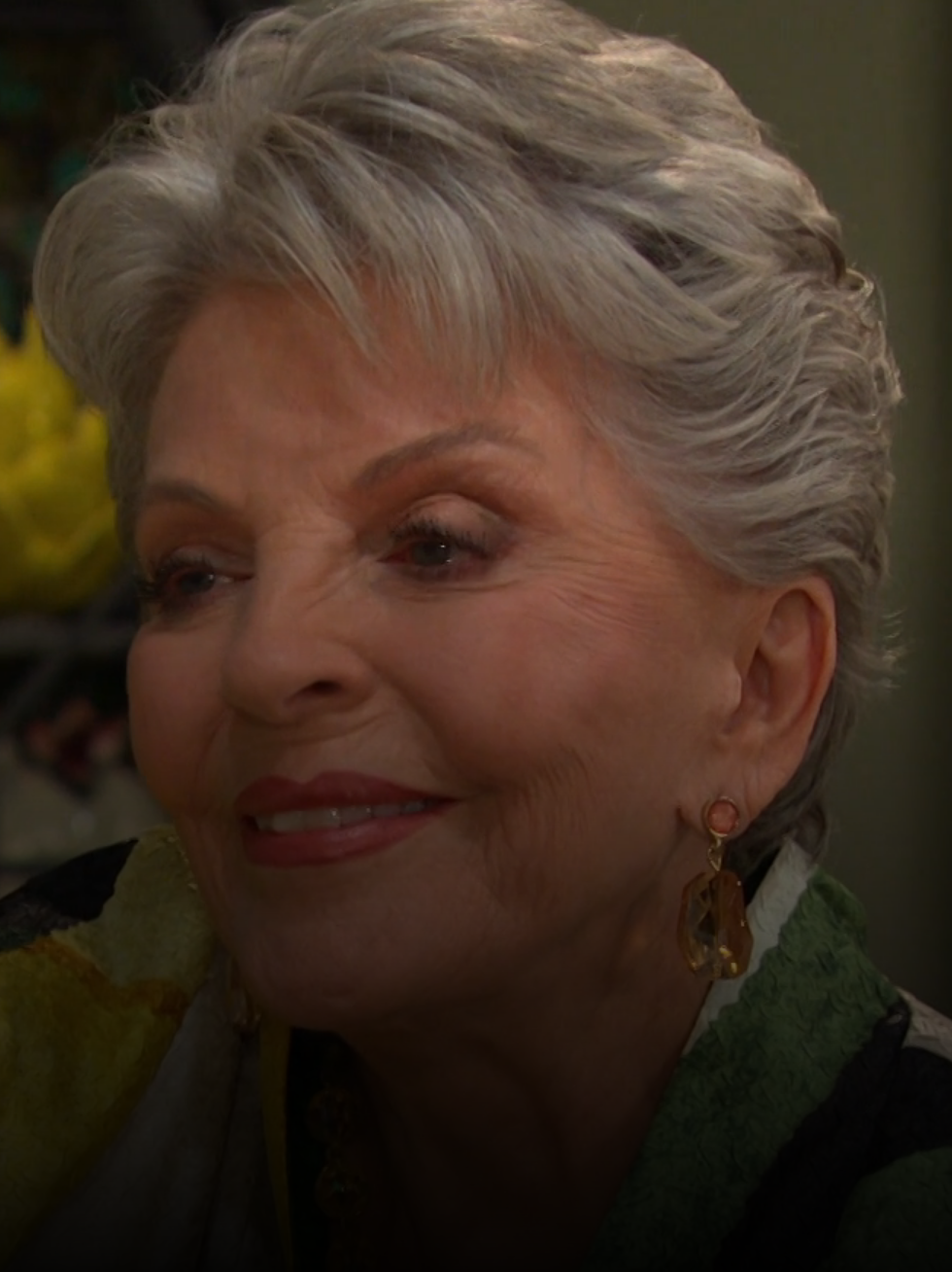 Julie smiles sadly at her wedding photo on Days of Our Lives during the week of 11-11-24