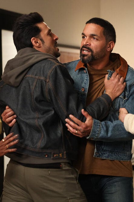 Dhan tries to stop a grieving father from attacking.