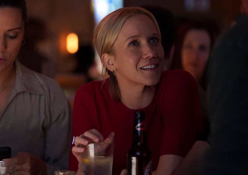 Hannah sitting at the bar and smiling with a beer in front of her on Chicago Med Season 10 Episode 7