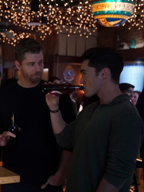 Frost drinking a beer while at a bar with Ripley, Doris, and Hannah on Chicago Med Season 10 Episode 7