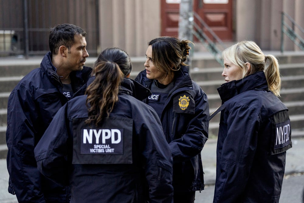 Rollins stands on the outside of a team huddle on Law & Order: SVU Season 26 Episode 8