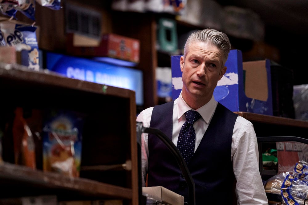 Carisi standing behind a shelf in a convenience on Law & Order: SVU Season 26 Episode 8