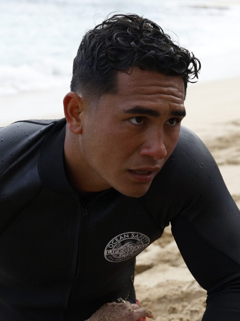 Laka provides assistance to a victim during Rescue HI-Surf Season 1 Episode 7.