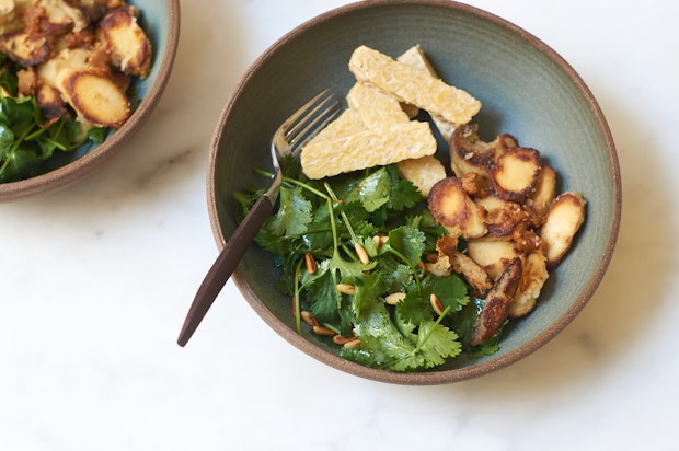 sake mushrooms in a bowl with a salad placed on a countertop