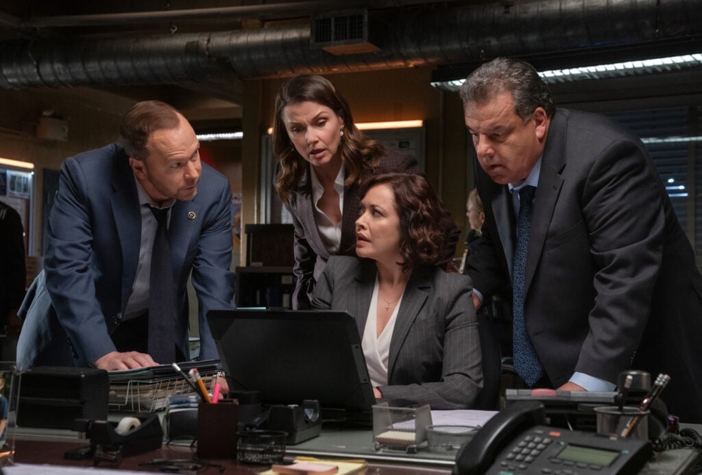 Danny, Baez, Erin, and Anthony look at some information on Baez's laptop to solve the case on Blue Bloods Season 14 Episode 18