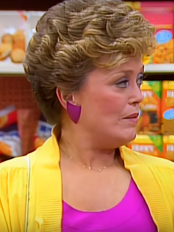 Blanche wears a bright yellow blazer in the grocery