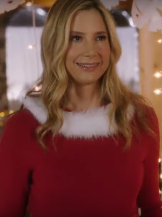 Mira Sorvino wears a red Santa sweater in Hallmark's A Christmas To Remember