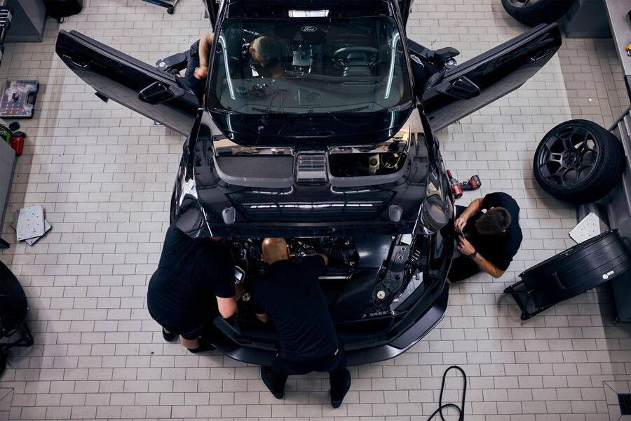 Ford mechanics working in the engine bay of the Mustang GTD