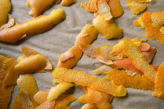 orange peels, grapefruit peels and lemon peels ready to be dried arranged on a baking sheet